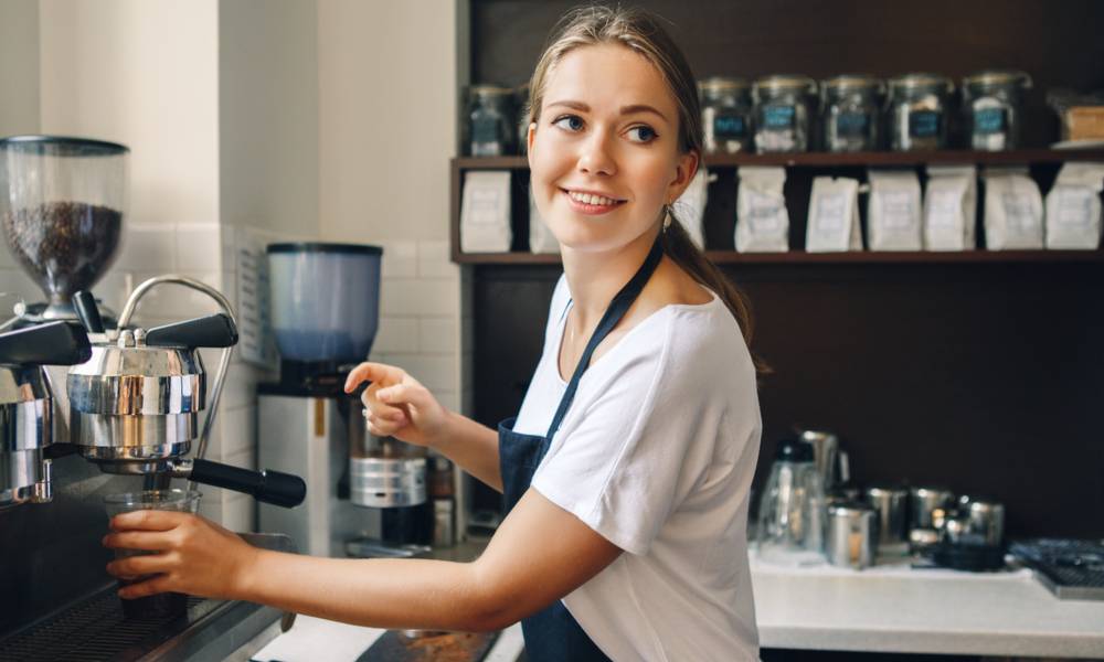 Young female barista fills a cup with espresso (1).jpg