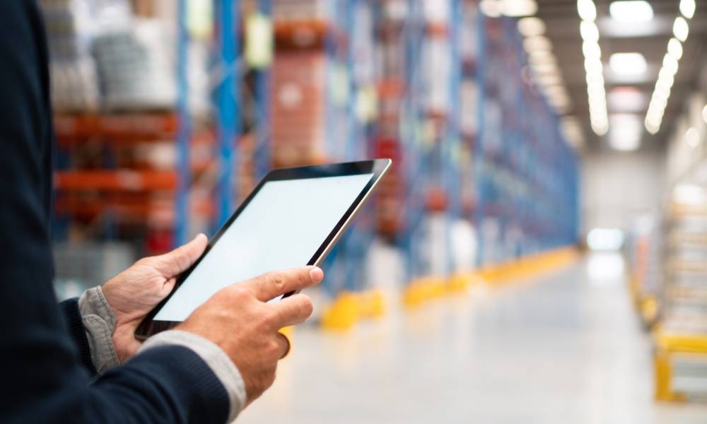 Businessman manager using tablet to manage warehouse logistics.jpg