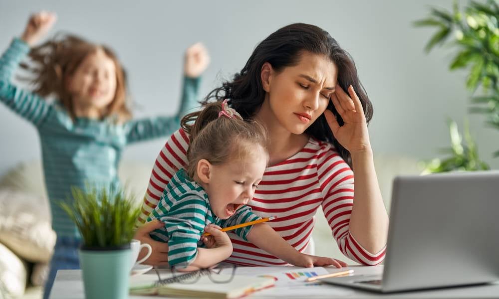 Woman caring for children while at work during lockdown burnout.jpeg