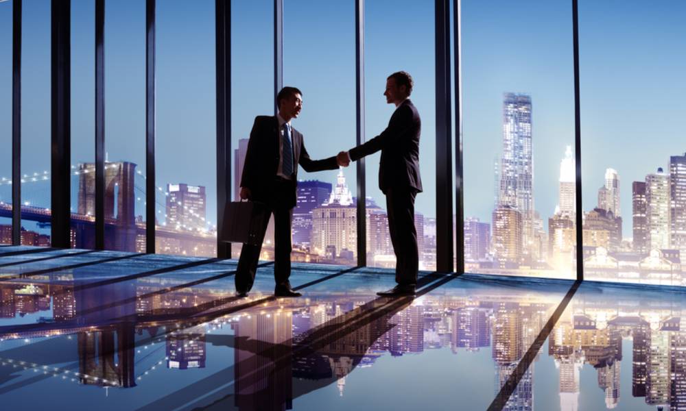 Businessmen shaking hands with city view (1).jpg