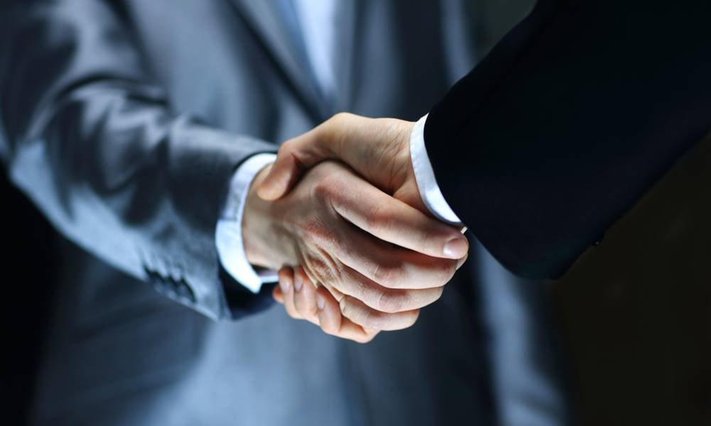 Businessmen shake hands global supply chains supplier networks.jpeg