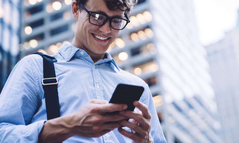 Confident employee businessman smiles at phone .jpeg