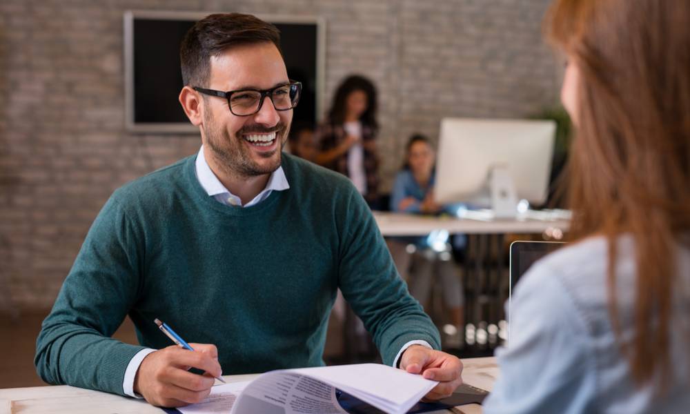 Businessman listens to candidate answers during job interview.jpg