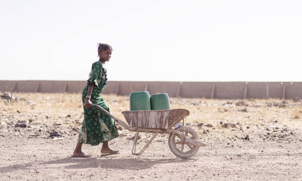 Girl carrying fresh water for lack of water symbol (1).jpg