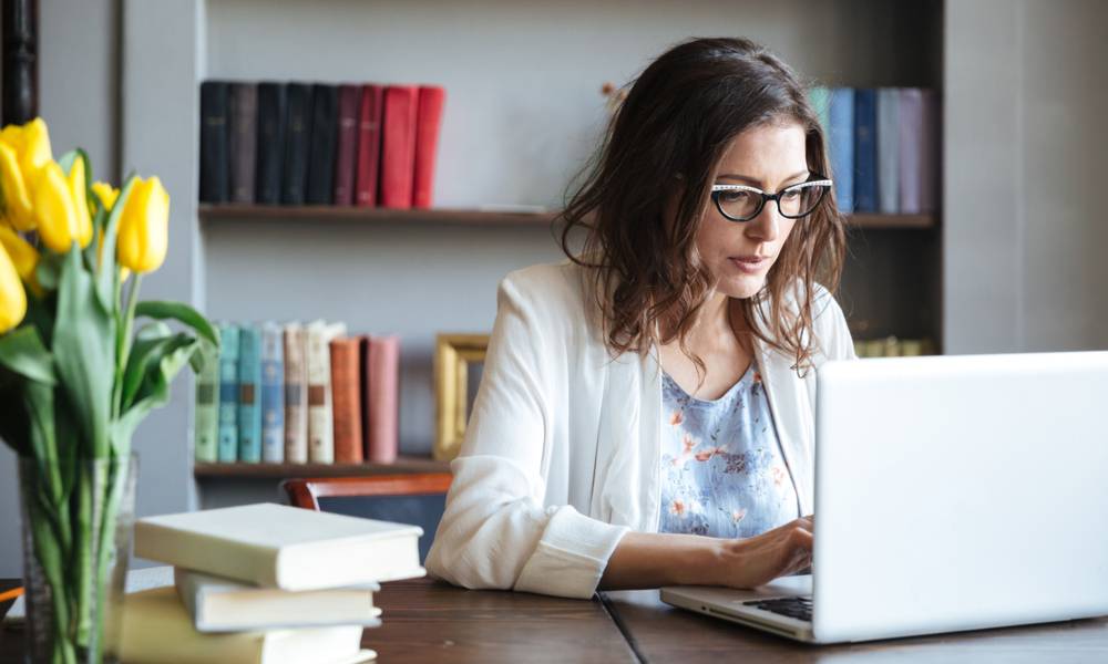 Portrait of a concentrated mature academic working on a laptop at home instead of an office (1).jpg