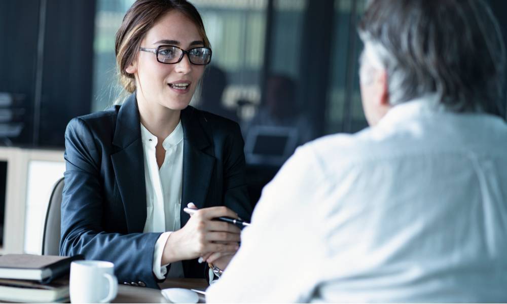 Woman in a suit talking with client about financial advice.jpeg