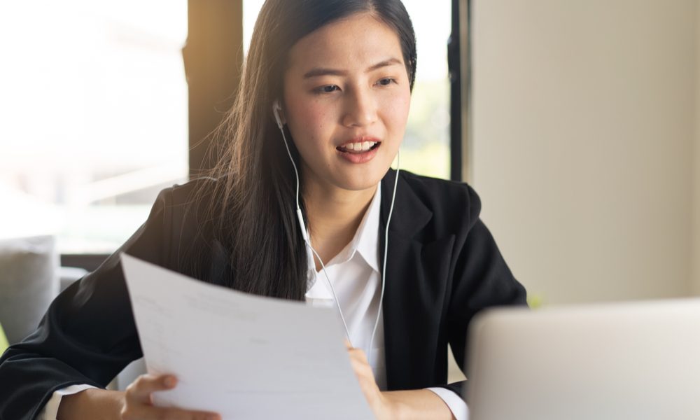 Woman wearing headphones sitting a virtual interview.jpeg