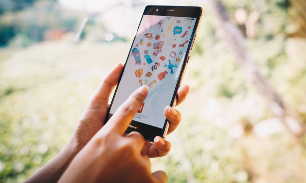 Woman holding HUAWEI with taobao on screen.jpg