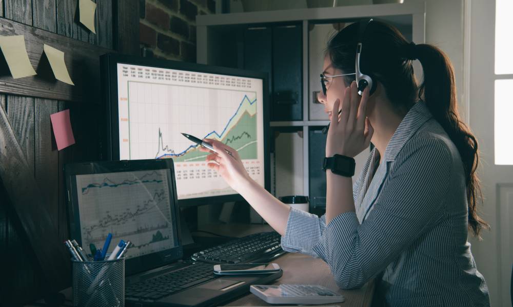 A trader wears headphones while looking at a stock chart.jpeg