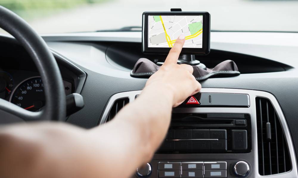 Close-up of hand using GPS navigation inside a car (1).jpg
