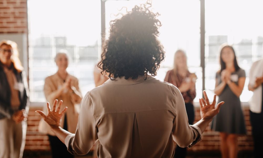 Woman speaking to a crowd of women.jpeg