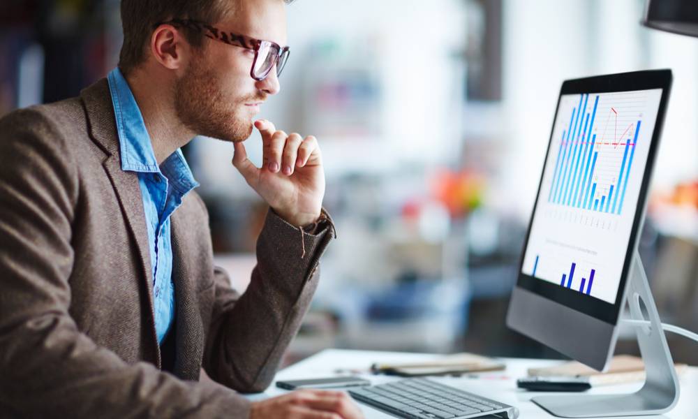 Businessman looking at computer screen with data (1).jpg