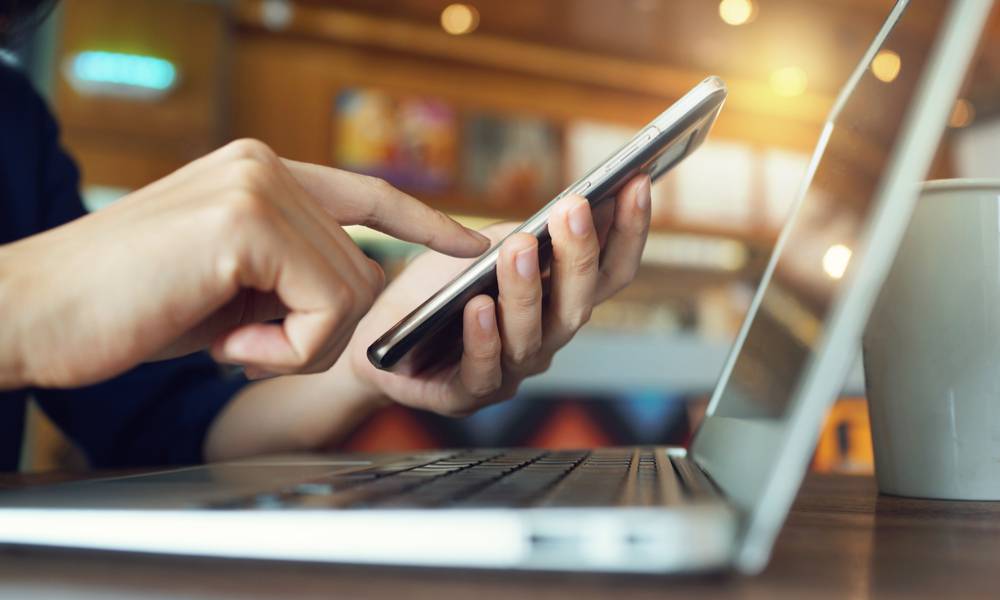 Close up of woman using smartphone in a cafe.jpg