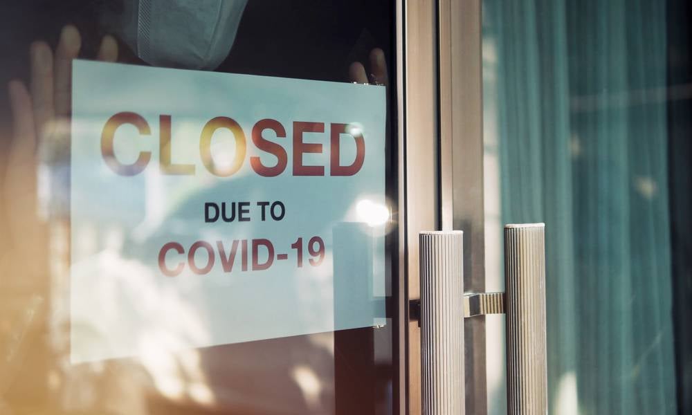 Sign outside small business reads closed due to COVID-19 pandemic.jpeg
