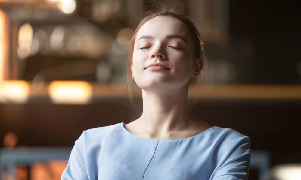 Woman takes a deep breath emotions at work team.jpeg