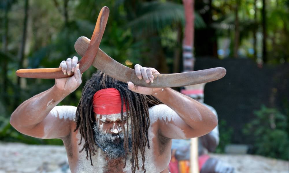 Australian Aboriginal man holds boomerangs during Aboriginal culture show in tropical far north of Queensland, Australia..jpg