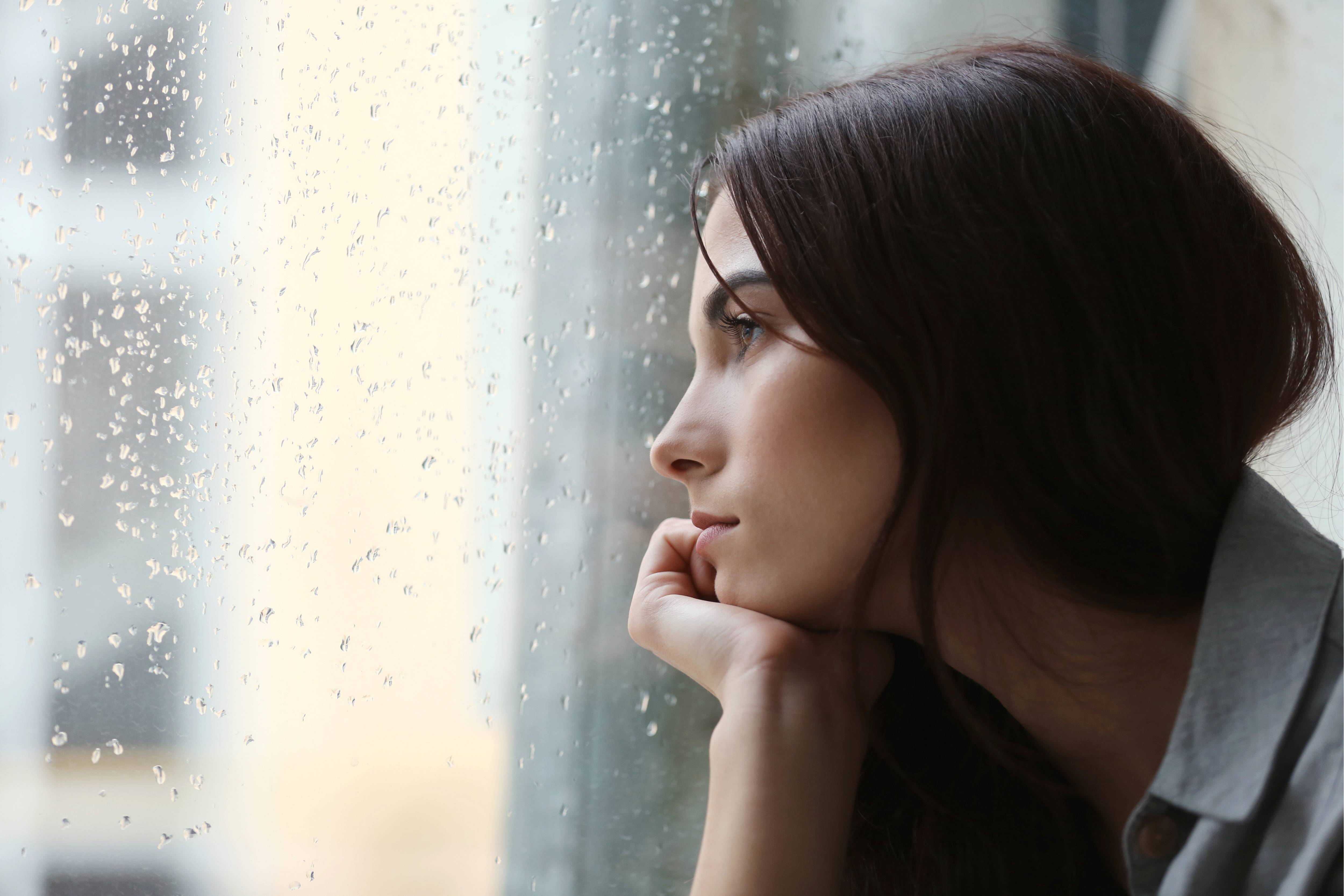 Woman stares out of window into the rain  (1).jpg