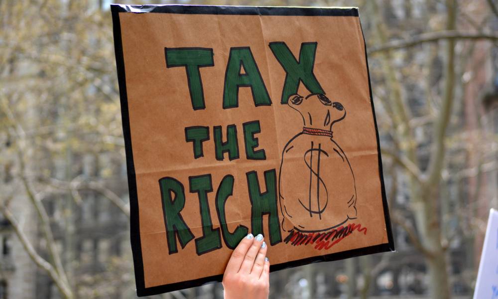 Sign says tax the rich.jpeg