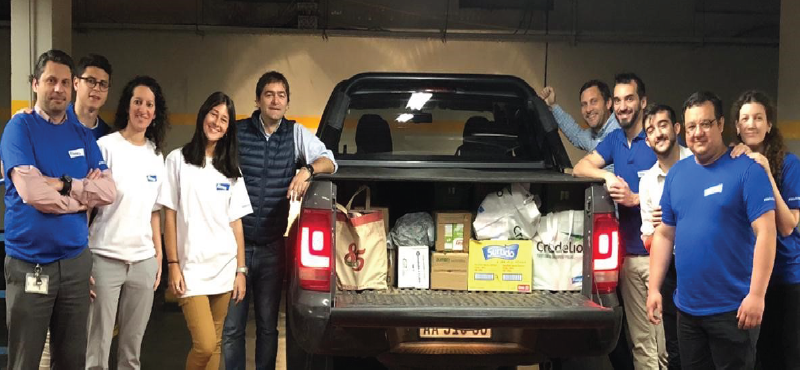 Elanco employees standing by a truck full of goods for GDOP