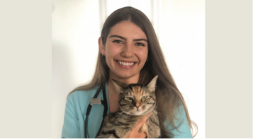 a photo of intern Rachel Sullivan holding a cat