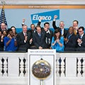 group of people infront of Elancos office logo clapping and punching the air