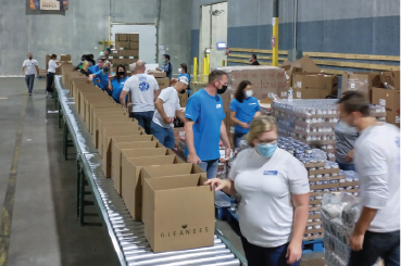 a group of Elanco employees packaging meals