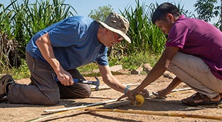 two people working on a structure together
