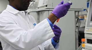 man in lab with syringe