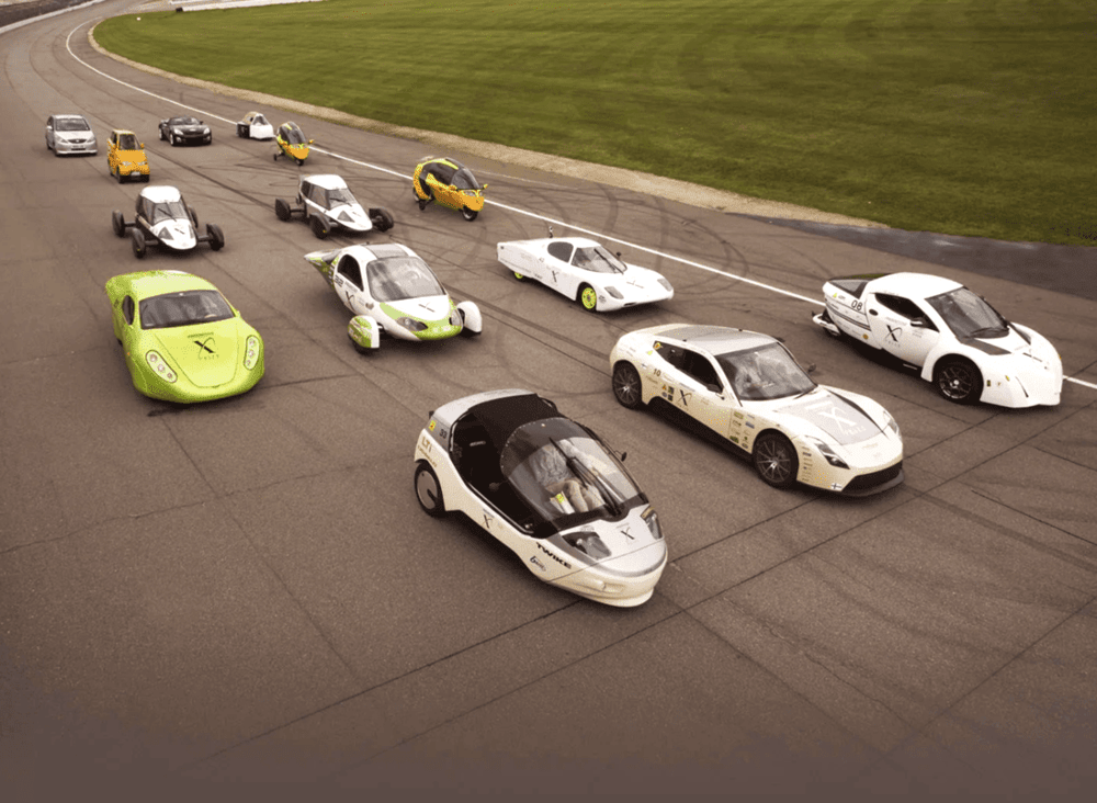 14 very light cars (VLCs) competing in the Progressive Automotive XPRIZE on a racetrack