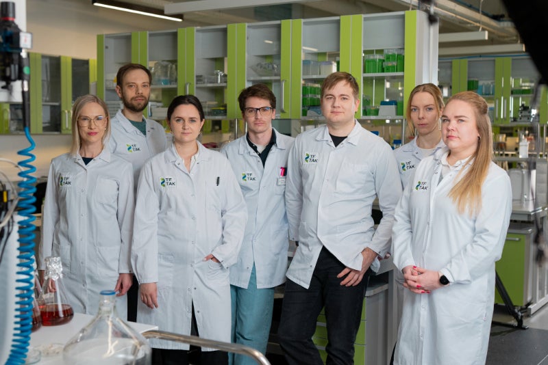 TFTAK team wearing white lab coats.
