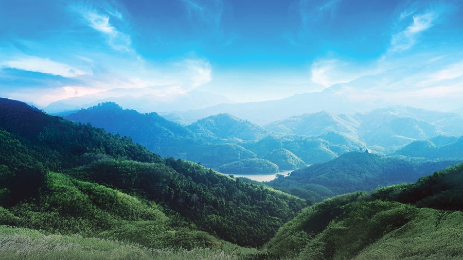 A mountain range extends into the distance under a blue sky