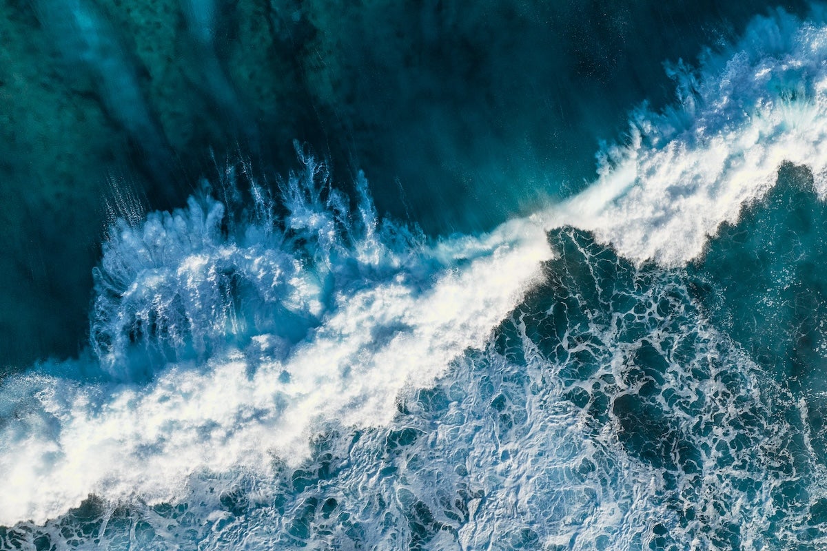 Ocean waves crashing, as seen from above