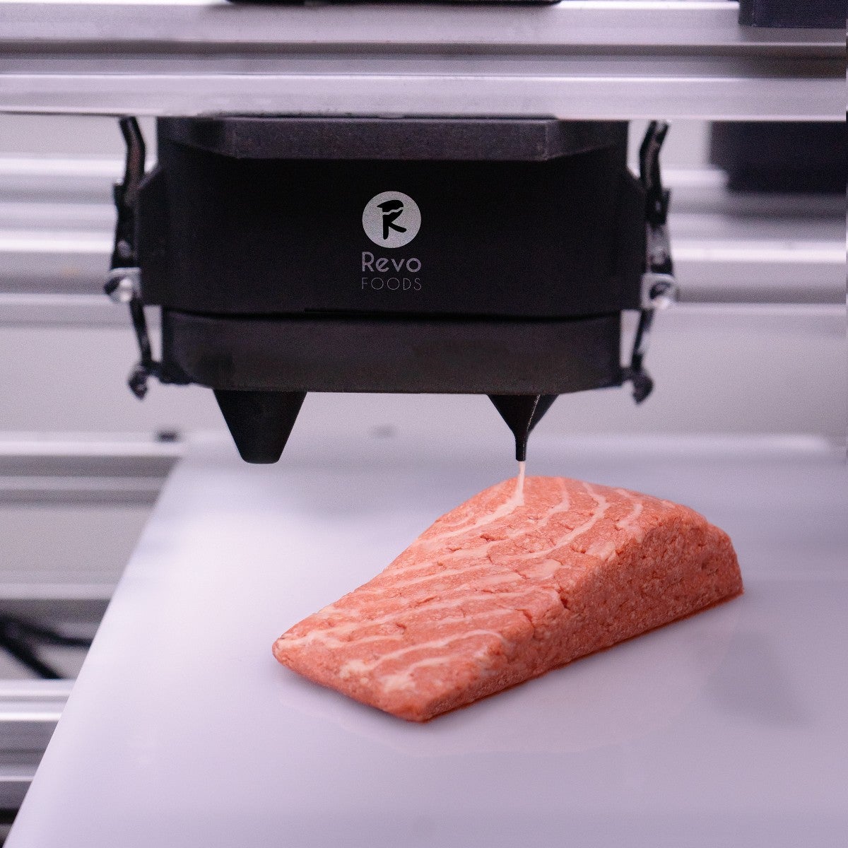 Salmon being extruded out of Revo Foods' machine