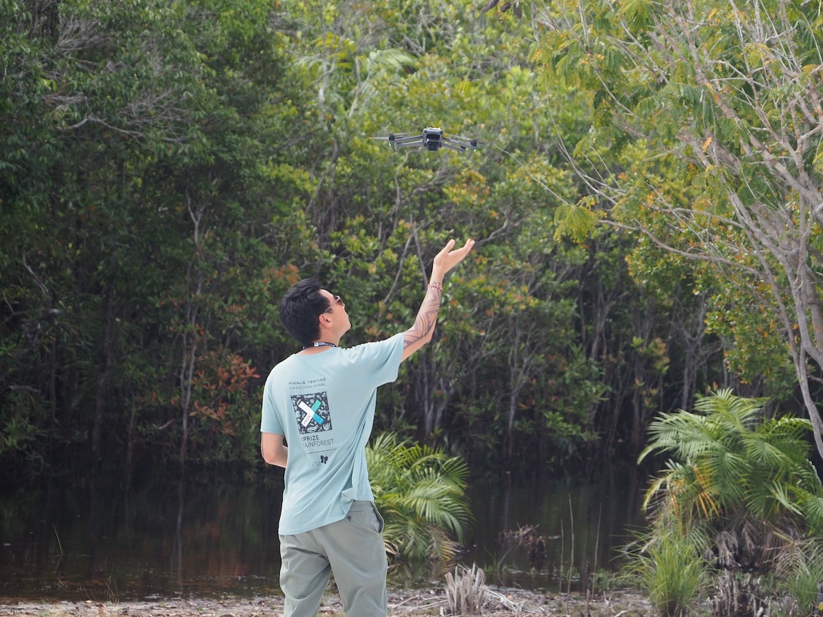 A finalist XPRIZE Rainforest team releases a drone in Amazonas, Brazil during the competition.