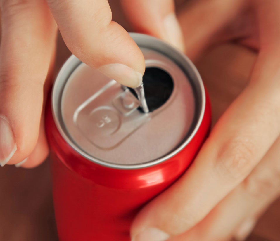 Hand opening a can of soda