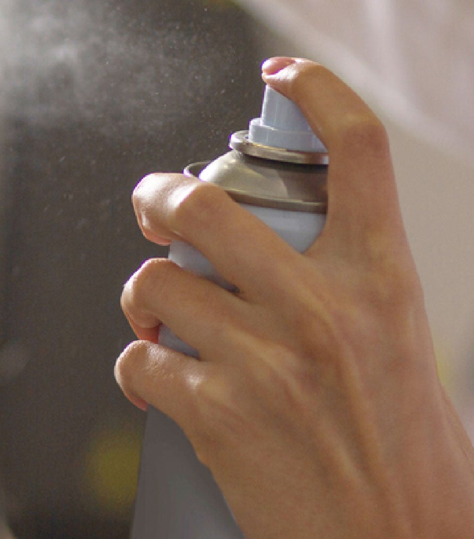 hand spraying an aerosol can