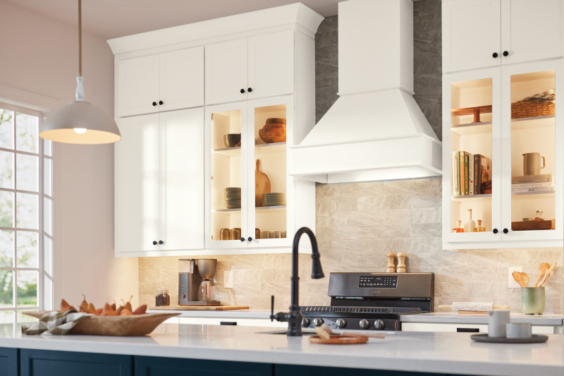 A kitchen with white cabinets and light counters.