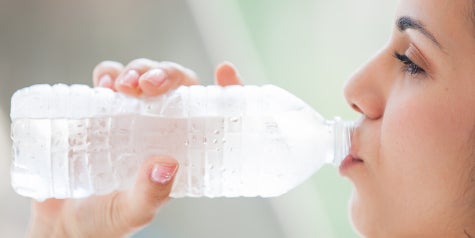 Woman drinking bottled water.