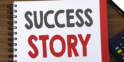 Success Story words written on a notebook