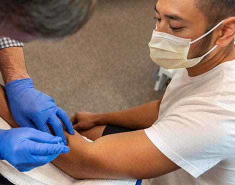 physical therapist using functional dry needling treatment on a patient.