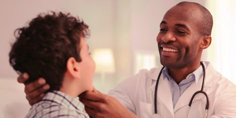 Doctor examines child in a clinic