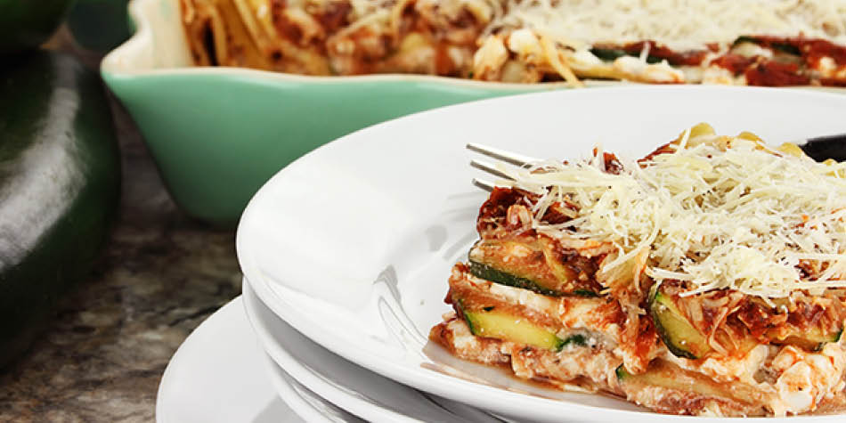 Zucchini noodles arranged like lasagna with pizza-Italian flavors and topped with cheese