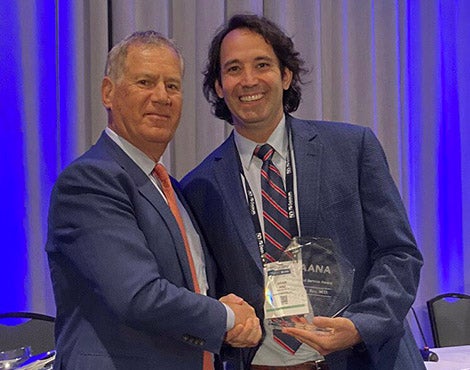 Dr. Anz receiving award at recent conference for his research.