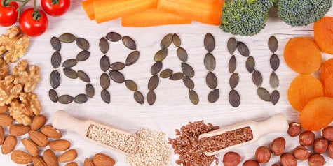 The word BRAIN is spelled out with seeds with nutritious foods surrounding it