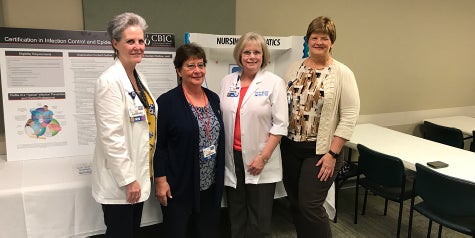 Four nurses gather from Baptist Health Care to honor other nurses for their achievements.