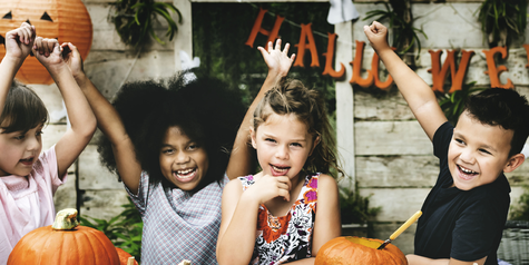 Kids enjoying carving pumpkin for halloween.