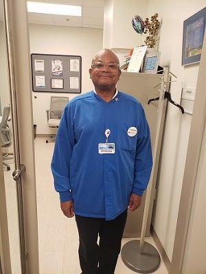 Longtime Baptist volunteer Willie Johnson is seen in his volunteer outfit at hospital