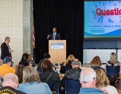 Dr. Balfour speaking to symposium attendees