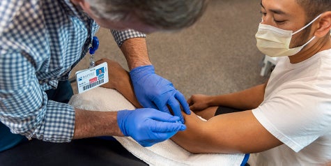 Physical therapist using functional dry needling on a patient.