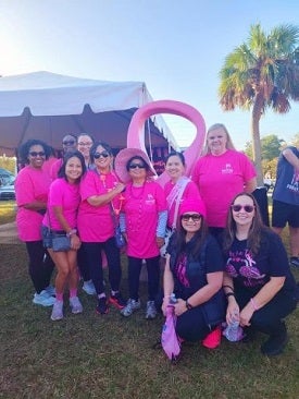 Ladies in a group wearing pink for support of breast cancer